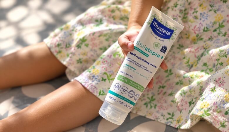 Kids and Eczema: What Has Actually Helped Our Family Child holding Mustela Stelatopia+ Lipid-Replenishing Cream for dry, eczema-prone skin